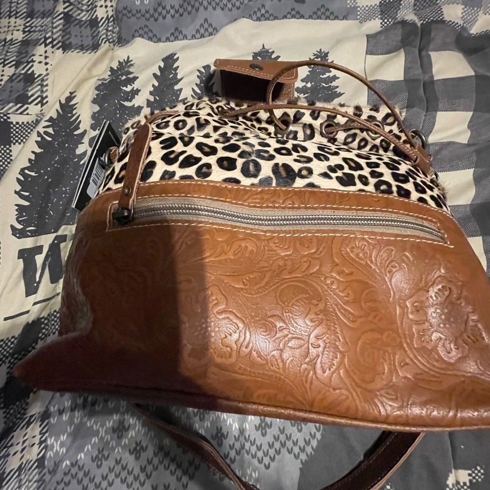 Myra bag with drawstring closure and an adjustable strap. New with tags